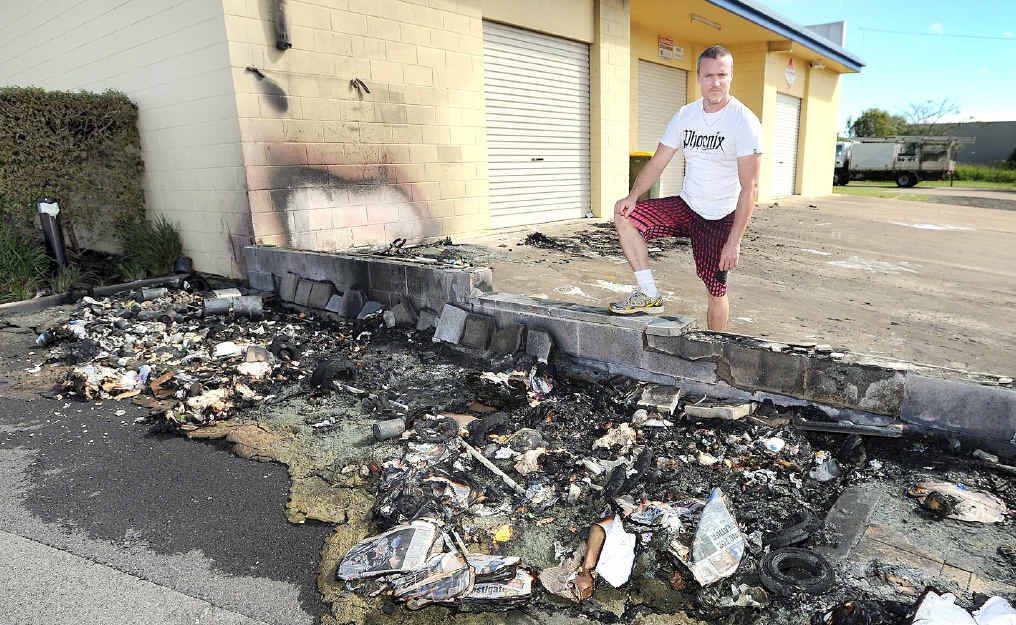 Menus on Main owner Ben Hosking surveys damage caused by wheelie bin fires behind Main St. Menus on Main owner Ben Hosking surveys damage caused by wheelie bin fires behind Main St.